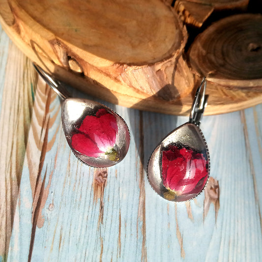 Earrings with real red roses in jewelry resin.