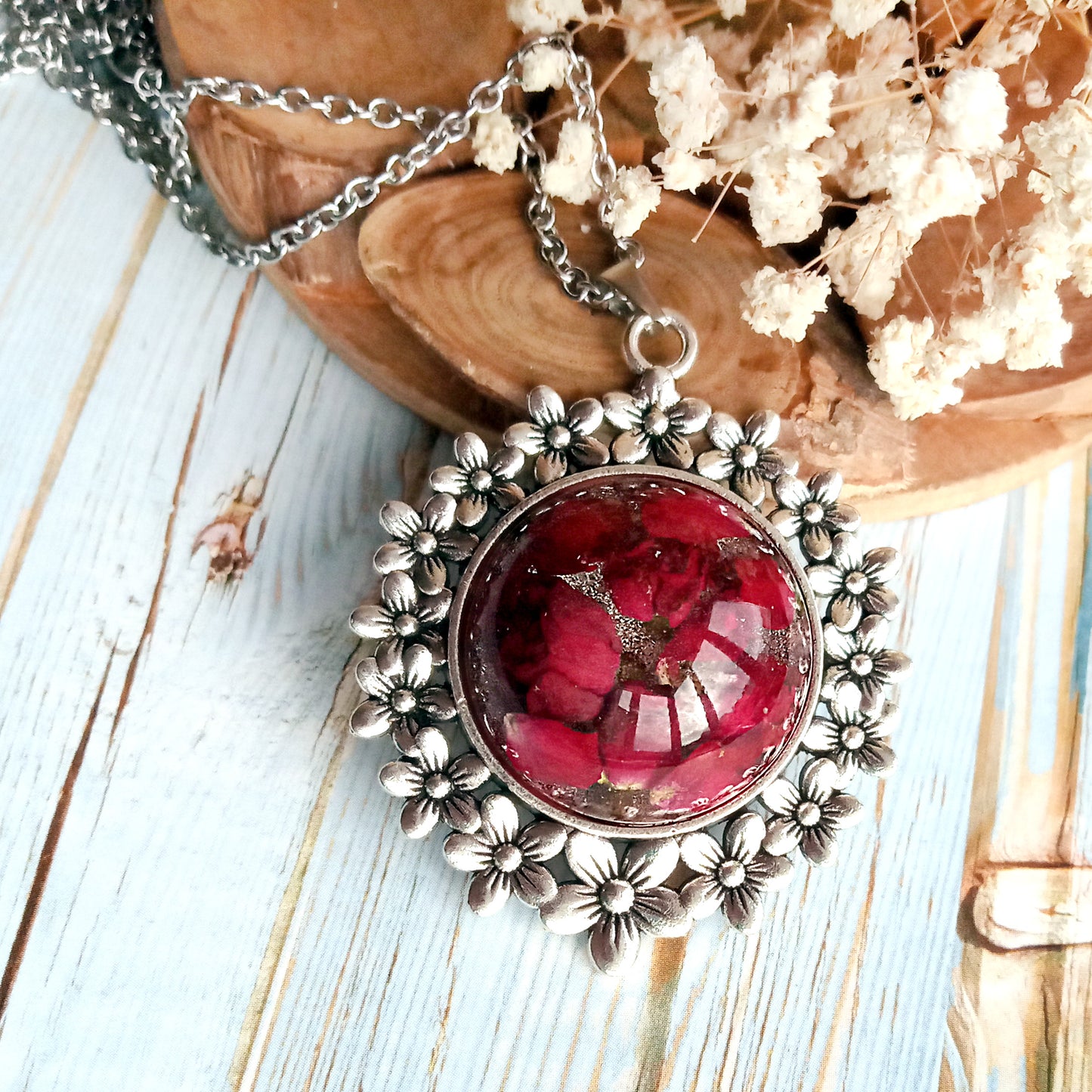 Red roses in resin jewelry pendant