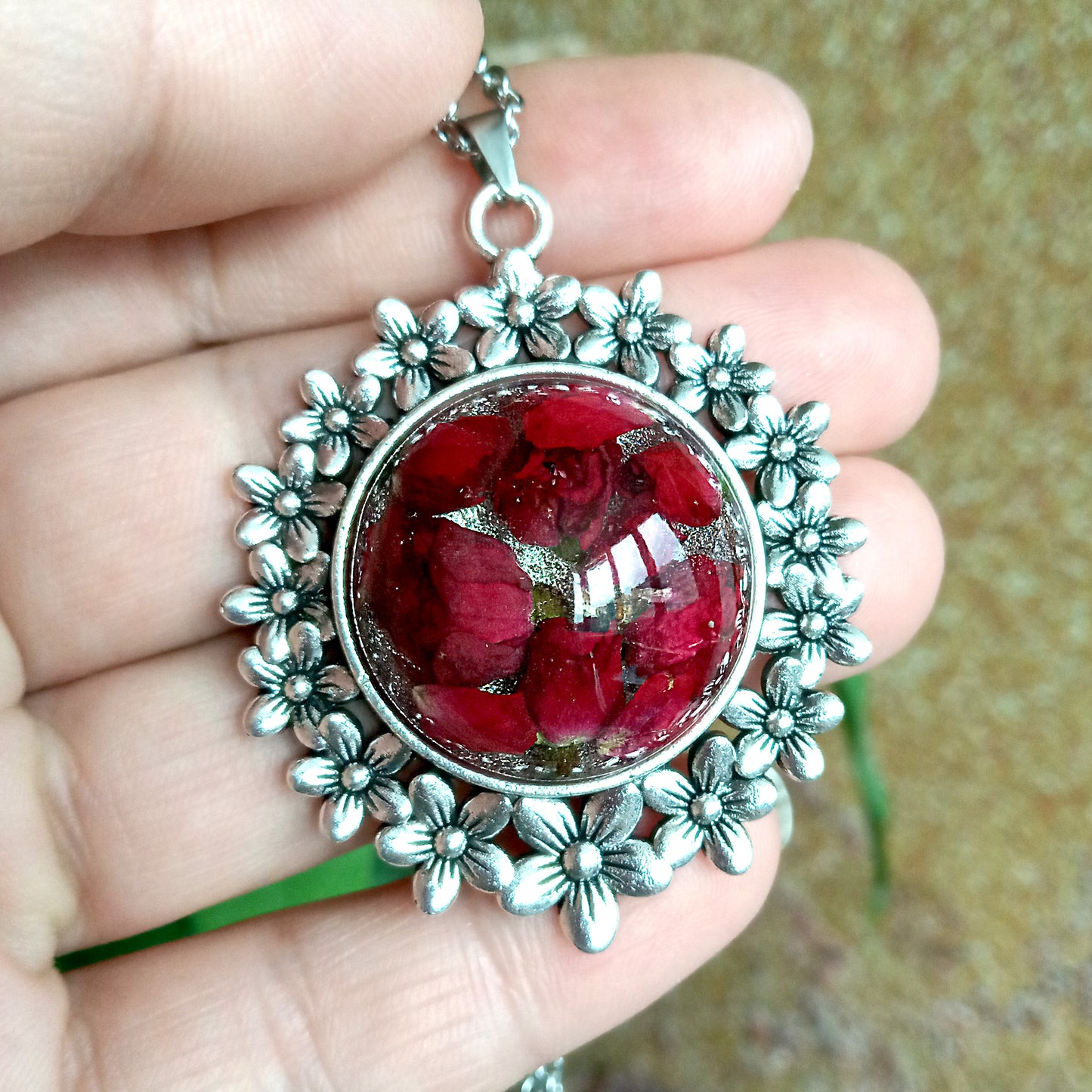 Red roses in resin jewelry pendant