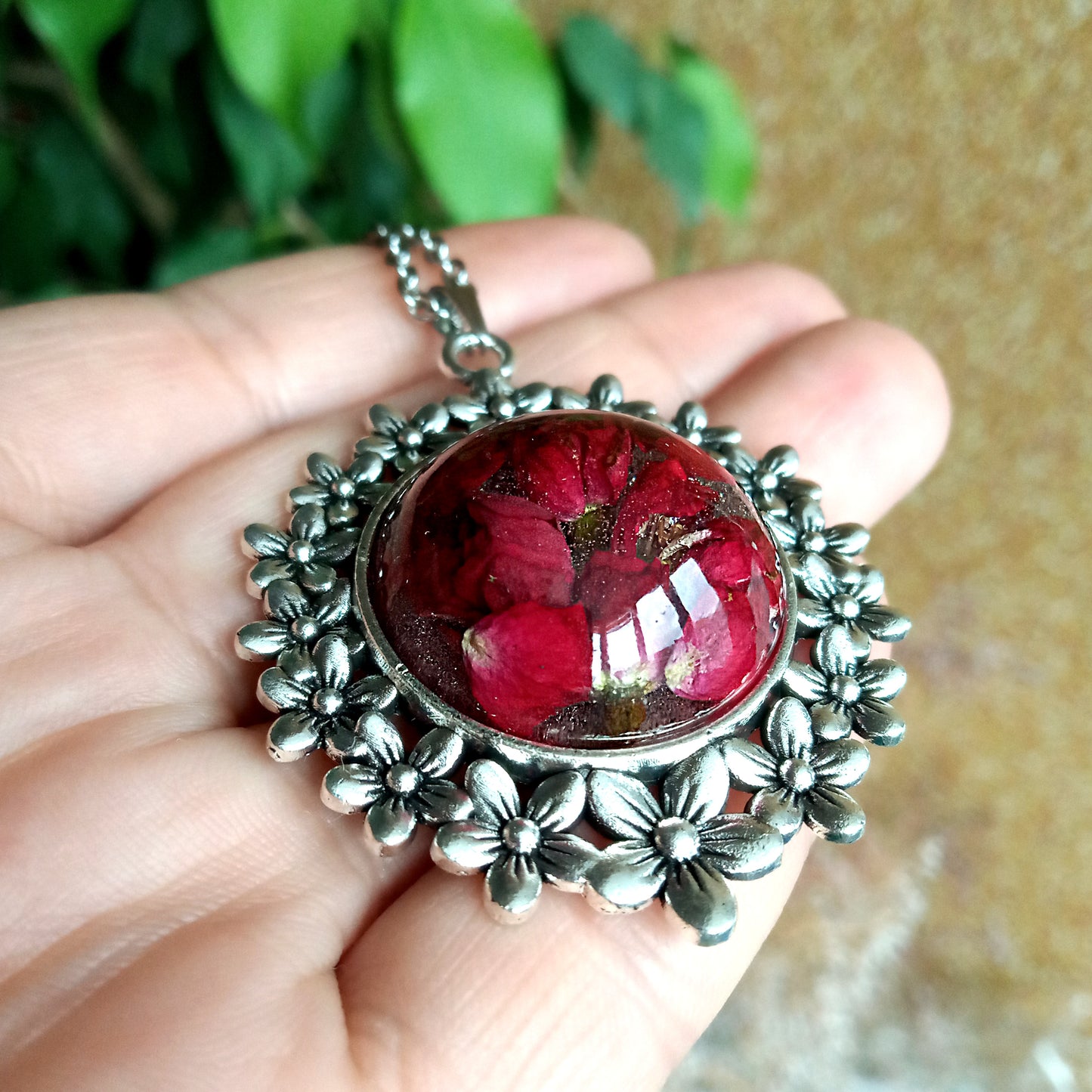 Red roses in resin jewelry pendant