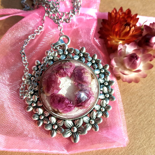 Pink roses in resin jewelry pendant.