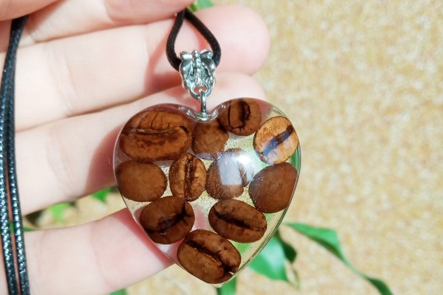 Pendant with coffee beans in epoxy resin.