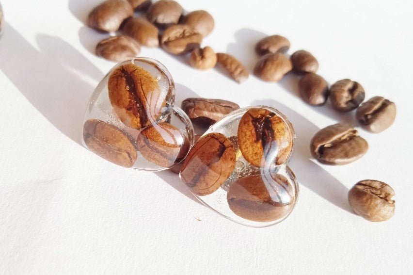 Earrings with coffee beans in epoxy resin.