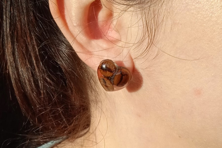 Earrings with coffee beans in epoxy resin.