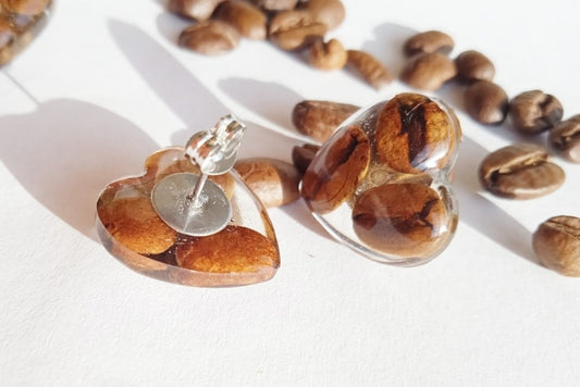 Earrings with coffee beans in epoxy resin.